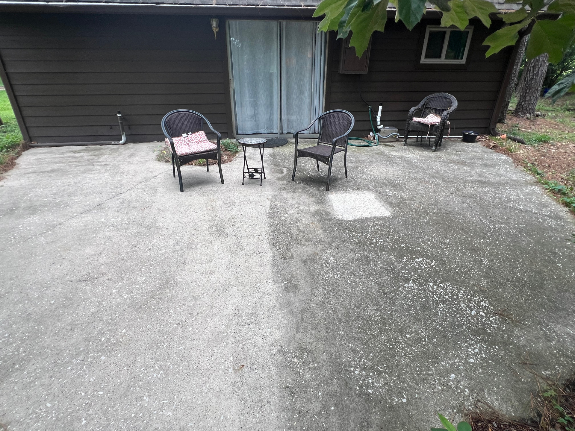 Patio at twenty-three months, sealed half holding original tone, unsealed half darker and dirtier